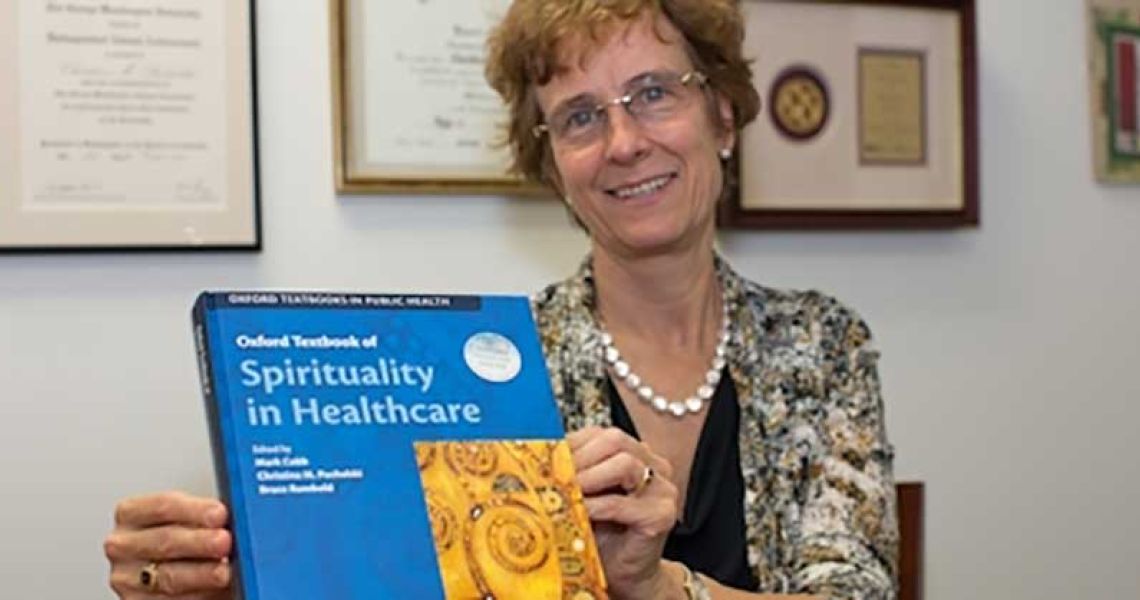 Dr. Puchalski holding Spirituality and Healthcare