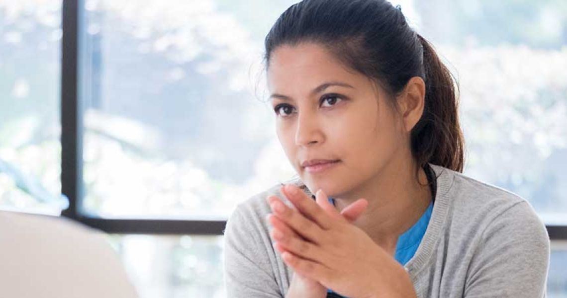 Woman with hands clasped