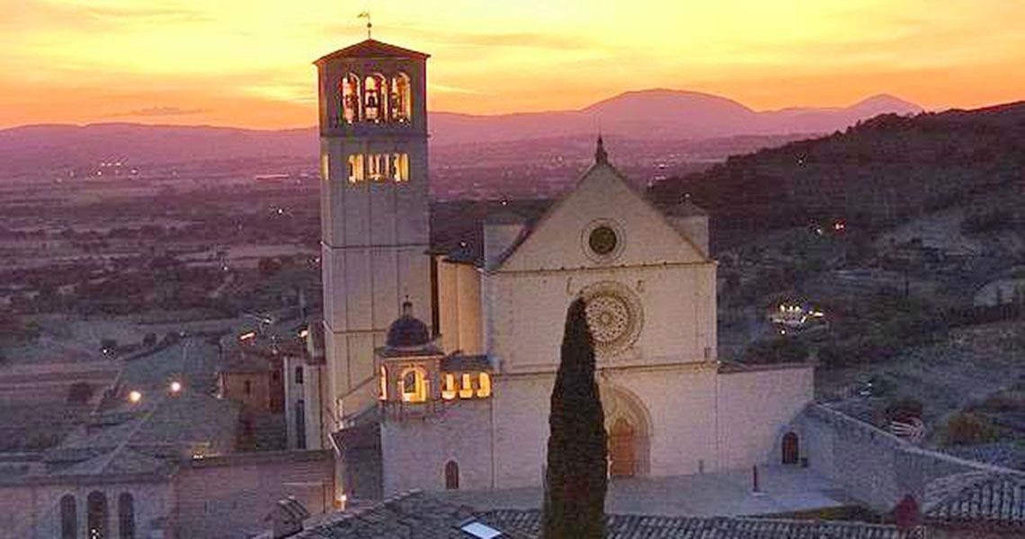 A sunset over a church in Assisi, Italy