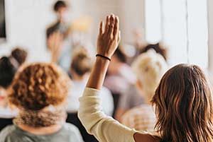 Woman raised hand in class