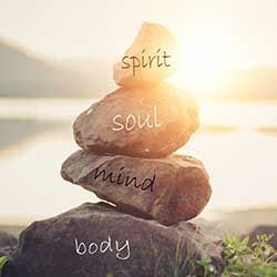 Spirit, soul, mind, and body written on rocks