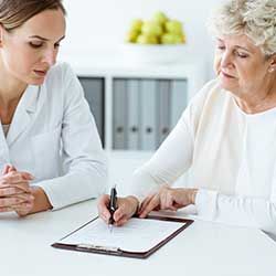 female nurse explaining results with elderly patient